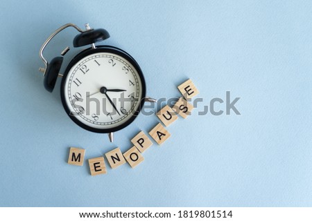 Concept. The inscription from the letters menopause. Symptoms of Menopause Harmonious changes in women older than 40 years. Royalty-Free Stock Photo #1819801514