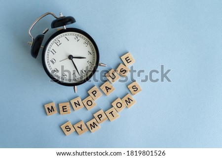 Concept. The inscription from the letters menopause. Symptoms of Menopause Harmonious changes in women older than 40 years. Royalty-Free Stock Photo #1819801526