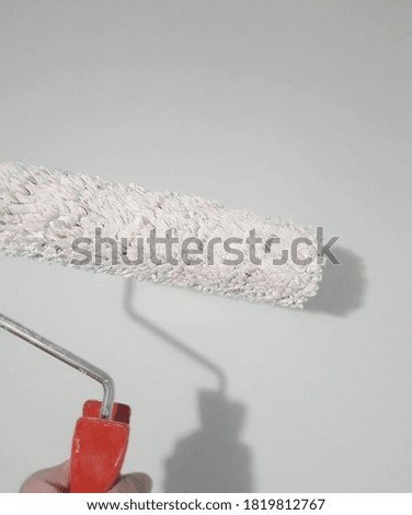 Paint roller on a wall