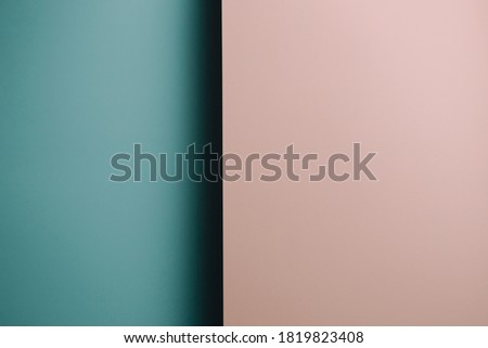A pink and blue pastel flat lay background with sharp layers and shadows with copy space gender