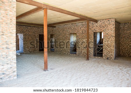 Construction of houses. Walls, brick internal partitions, ceiling made of blocks covered with clay, metal supports.