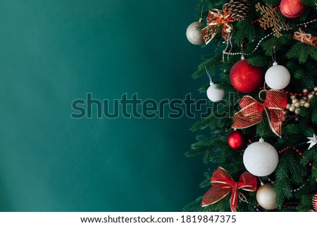 Christmas tree pine decorated with toys with gifts green background new year