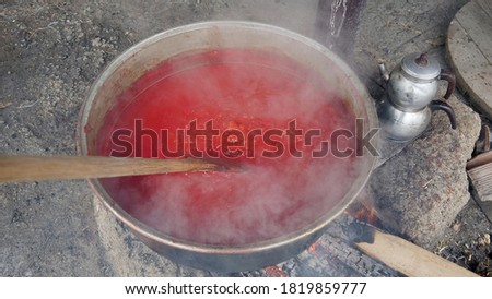 The tomato sauce made with traditional methods in Turkey. Natural, additive-free. in a copper pot. It is boiling over wood fire.