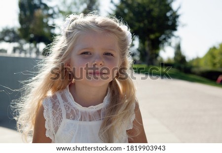 beautiful little girl in a white dress as a portrait closeup