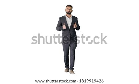 Bearded turk businessman walking and talking to camera on white Royalty-Free Stock Photo #1819919426