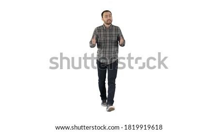 Handsome hispanic man model talking to the camera and walking on