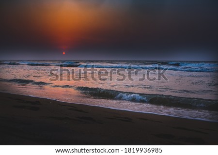 Beautiful sunrise over the beach in long exposure. Moving elements sunrise and wave photography from the beach in chennai, india. Red sky in bay of bengal. Sea Waves photography. ECR beach