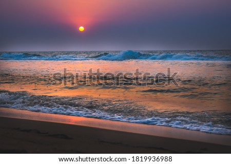 Beautiful sunrise over the beach in long exposure. Moving elements sunrise and wave photography from the beach in chennai, india. Red sky in bay of bengal. Sea Waves photography. ECR beach