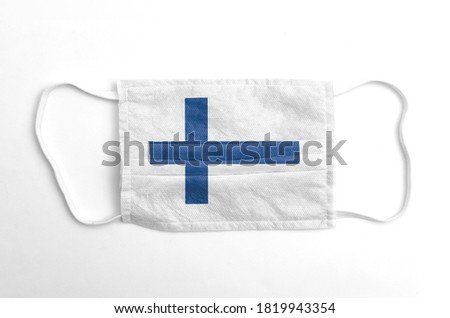 Face mask with Finland flag printed, on white background, isolated.
