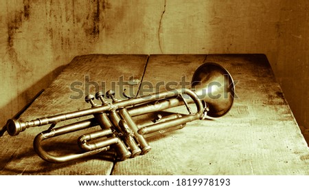 an old jazz trumpet on an antique table Royalty-Free Stock Photo #1819978193