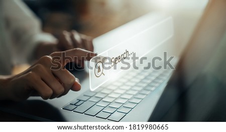 Hand using laptop and press screen to search Browsing on the Internet online.
