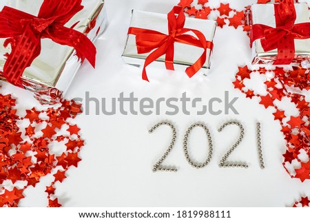 Composition 2021 Happy New Year and Merry Christmas in white and red colors. Decorative flat lay, top view, copy space