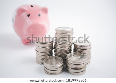 Close up of Coins stack and piggy pink on the white background, Business Finance and Money concept,Save money for prepare in the future concept, Copy space