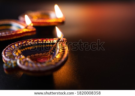 Indian festival Diwali, Diya oil lamps lit on colorful rangoli. Hindu traditional. Happy Deepavali. Copy space for text. Royalty-Free Stock Photo #1820008358