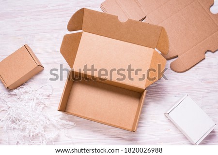 Brown cardboard flat postal box, case, on wooden desk