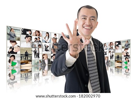 Asian business man or boss standing in front of tV screen wall showing pictures of business concept.
