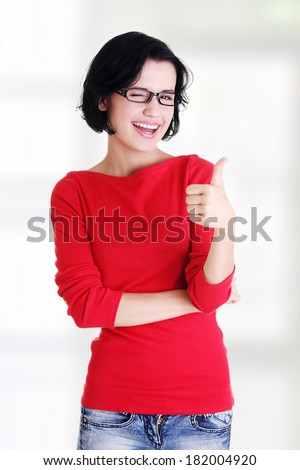 Beautiful young woman in casual clothes gesturing thumbs up. 