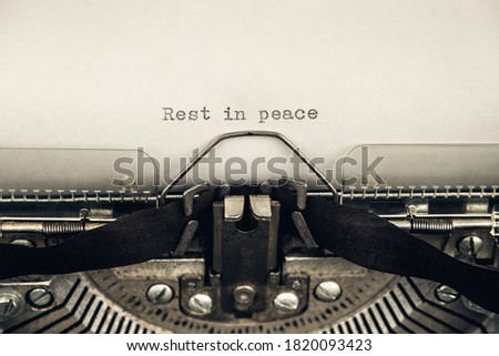 typing a message rest in peace on a vintage typewriter close-up