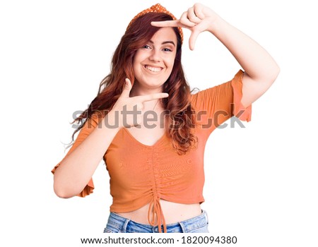 Young beautiful woman wearing casual clothes smiling making frame with hands and fingers with happy face. creativity and photography concept. 