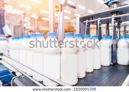 Bottling milk production line factory, industry equipment dairy plant. Royalty-Free Stock Photo #1820095709