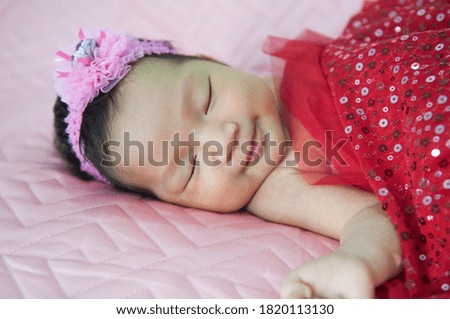 Sleeping newborn baby in a wrap