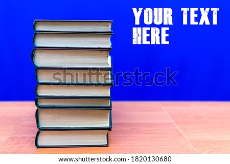stack of old books, grungy background, free copy space trendy blue color background