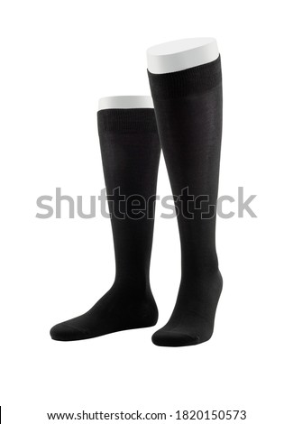 Black color socks isolated on white background. One pair of socks. Set of black socks for sports on foot as mock up for advertising, branding, design mockup, isolated, clipping path.
