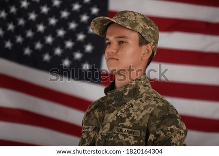 Male soldier and American flag on background. Military service