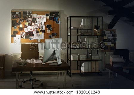 Modern detective office with computer and board