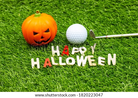 Golf Halloween with golf ball and Pumpkin Ghost on green grass