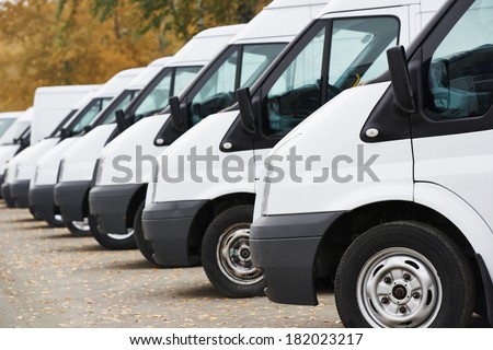 commercial delivery vans in row at parking place of transporting carrier shipping service company Royalty-Free Stock Photo #182023217