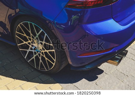 Stence culture. Blue underestimated car.Tuning. Rubber on stylish wheels. 