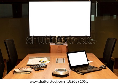 Mock up television and laptop with Clipping path on table in Video conference meeting room