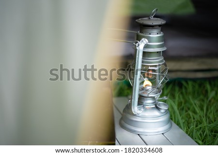 Oil lantern that lights up through a tent during the summer day