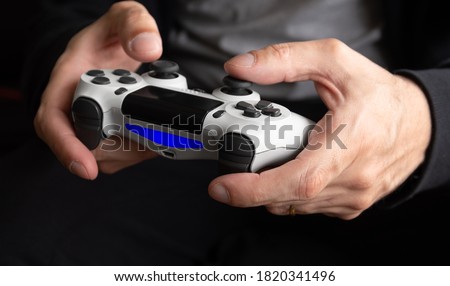 Man holding white game controller -  Seletive Focus Royalty-Free Stock Photo #1820341496