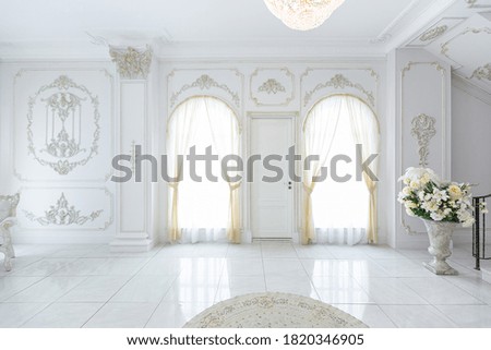 luxury royal posh interior in baroque style. very bright, light and white hall with expensive oldstyle furniture. large windows and stucco ornament decorations on the walls Royalty-Free Stock Photo #1820346905