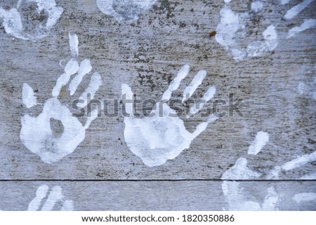 White Handprints on the Wood Wall
