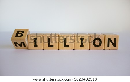 Turned a cube and changed the expression 'million' to 'billion'. Beautiful white background. Copy space. Business concept. Royalty-Free Stock Photo #1820402318