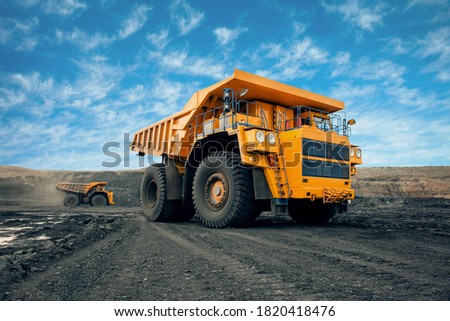 A large quarry dump truck in a coal mine. Loading coal into body work truck. Mining equipment for the transportation of minerals. Royalty-Free Stock Photo #1820418476