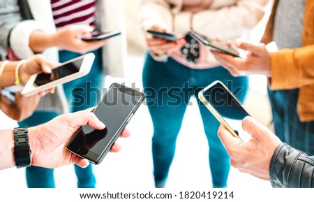 Friends group sharing content on mobile smart phone - Close up of people hands using tracking app with social media network - Technology concept with always connected millenials - Vivid bright filter Royalty-Free Stock Photo #1820419214