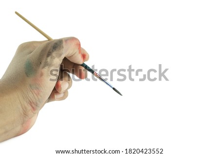 Hand holding paintbrush isolated on white background with clipping path