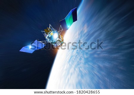 Space satellite rushes flies deorbiting in the Earth's orbit at high speed, lights sun reflected from solar panels. Elements of this image furnished by NASA