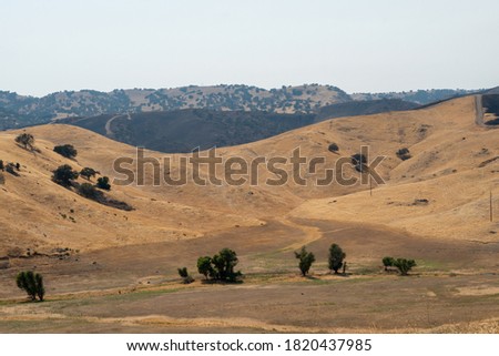 The San Luis Reservoir valley during dry and hot season, San Luis Creek in the eastern slopes of the Diablo Range of Merced County, California. USA Royalty-Free Stock Photo #1820437985