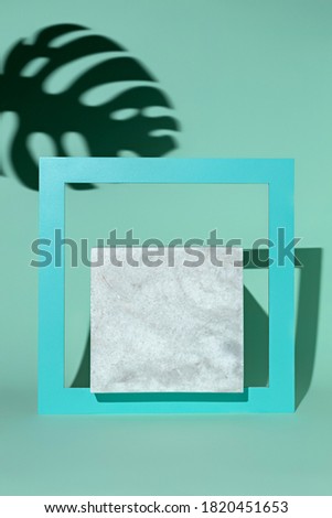 Luxury square podium with palm leaves and frames on turquoise background. Concept scene stage showcase, for product, promotion, sale, banner, presentation, cosmetic. Minimal showcase mock up concept.