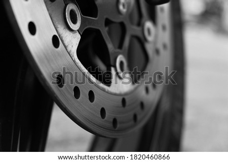 
brake disc on a wheel from a motorcycle close up macro. Black and white photo
