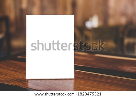 Mock up acrylic frame posters pattern template forms background, blank menu frame on table in coffee shop stand for your text of display your product.