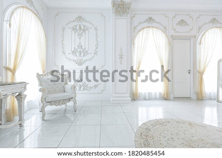 luxury royal posh interior in baroque style. very bright, light and white hall with expensive oldstyle furniture. large windows and stucco ornament decorations on the walls Royalty-Free Stock Photo #1820485454