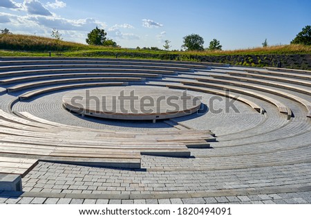 Small ancient roman amphitheatre in the park  Royalty-Free Stock Photo #1820494091