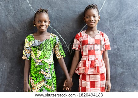 Couple of African Children Posing Indoors in School Building Holding Hands Royalty-Free Stock Photo #1820494163