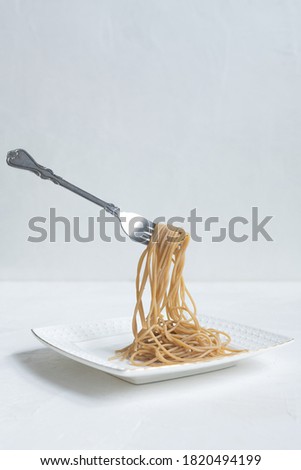 spaghetti made from buckwheat on a white table